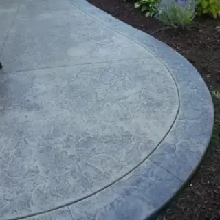 Curved decorative concrete patio design with rounded edges