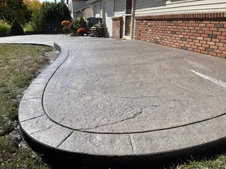 Large two-level stamped concrete patio in a Kansas City backyard