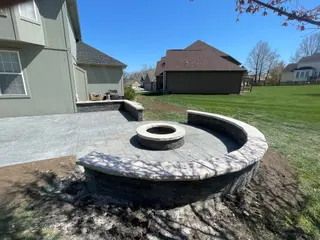 Stamped concrete patio with fire pit and seating wall in Kansas City