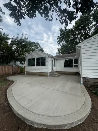 Curved backyard concrete patio at a Prairie Village, Kansas home