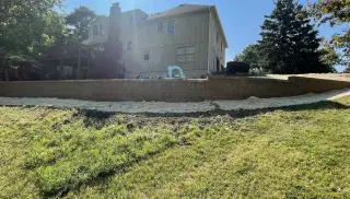 Backyard retaining wall stabilizing Olathe hillside