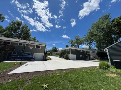 Expansive concrete driveway leading to backyard garage
