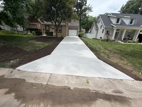 Long concrete driveway with flared apron at a Prairie Village, KS home