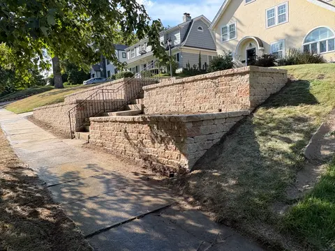 Side view of a tiered block retaining wall installation at a Kansas City home