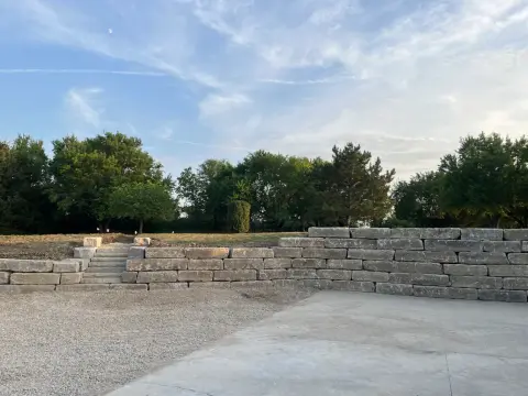 Large retaining wall with built-in stairs
